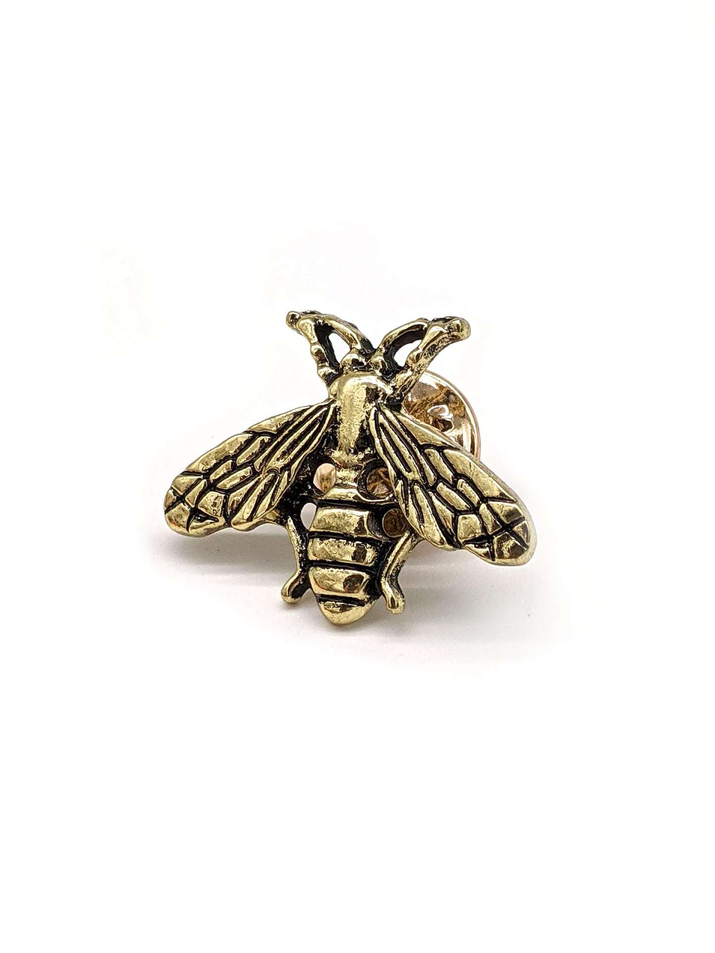 A golden bee-shaped pin designed for attachment to hats.