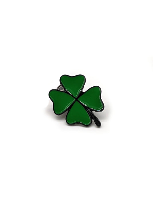 A green four-leaf clover brooch designed to be attached to a hat.