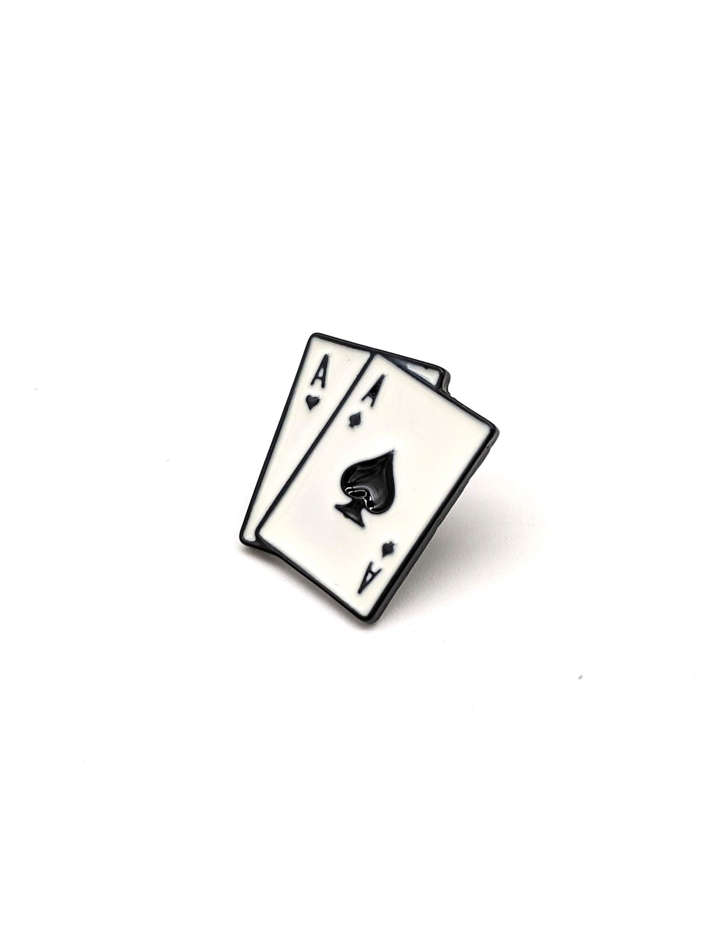 A brooch designed as two playing cards, specifically the Ace of Spades and the Ace of Diamonds, laid out parallel to each other.