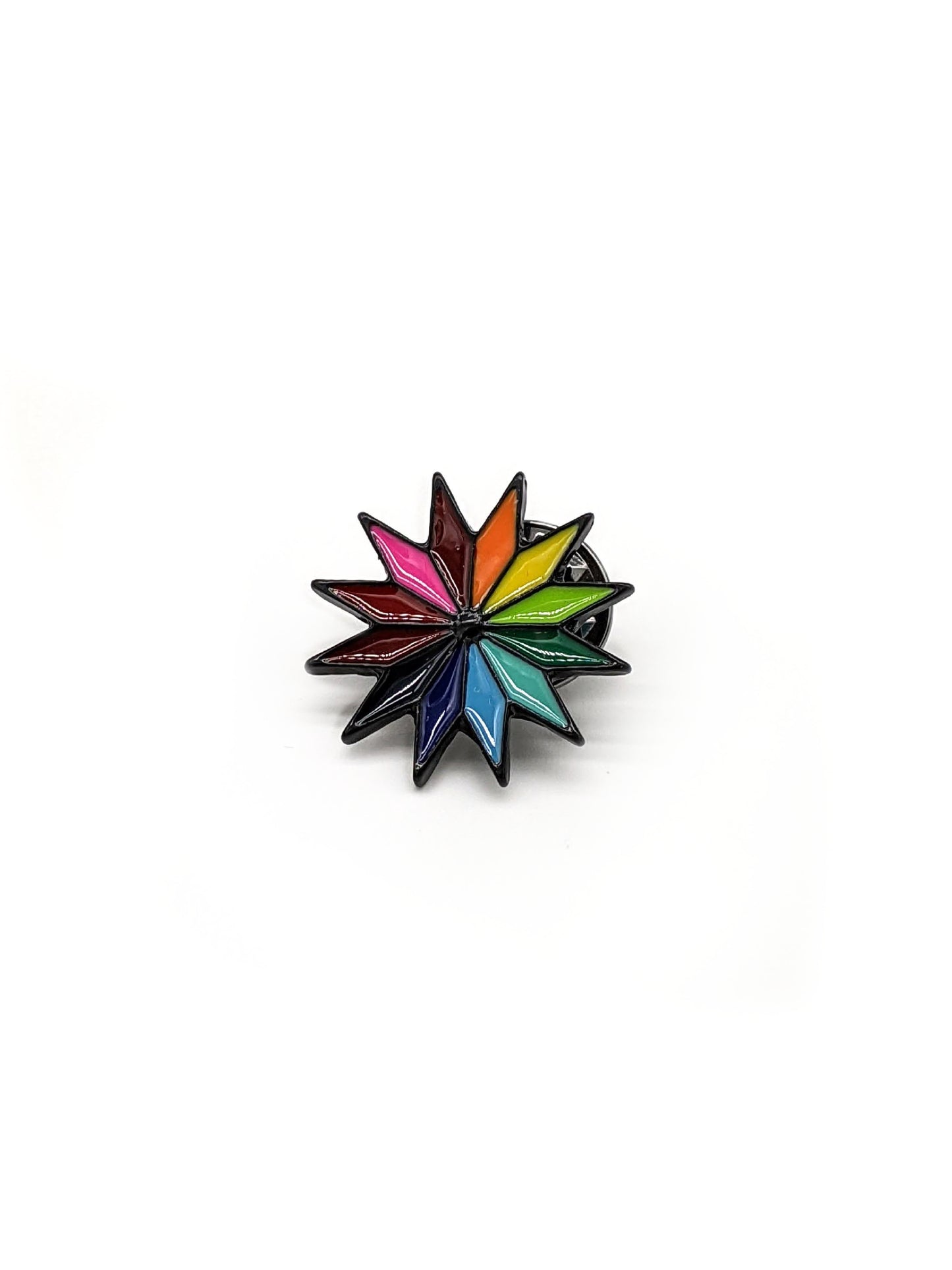 A colorful pinwheel-shaped brooch designed to be attached to a hat.