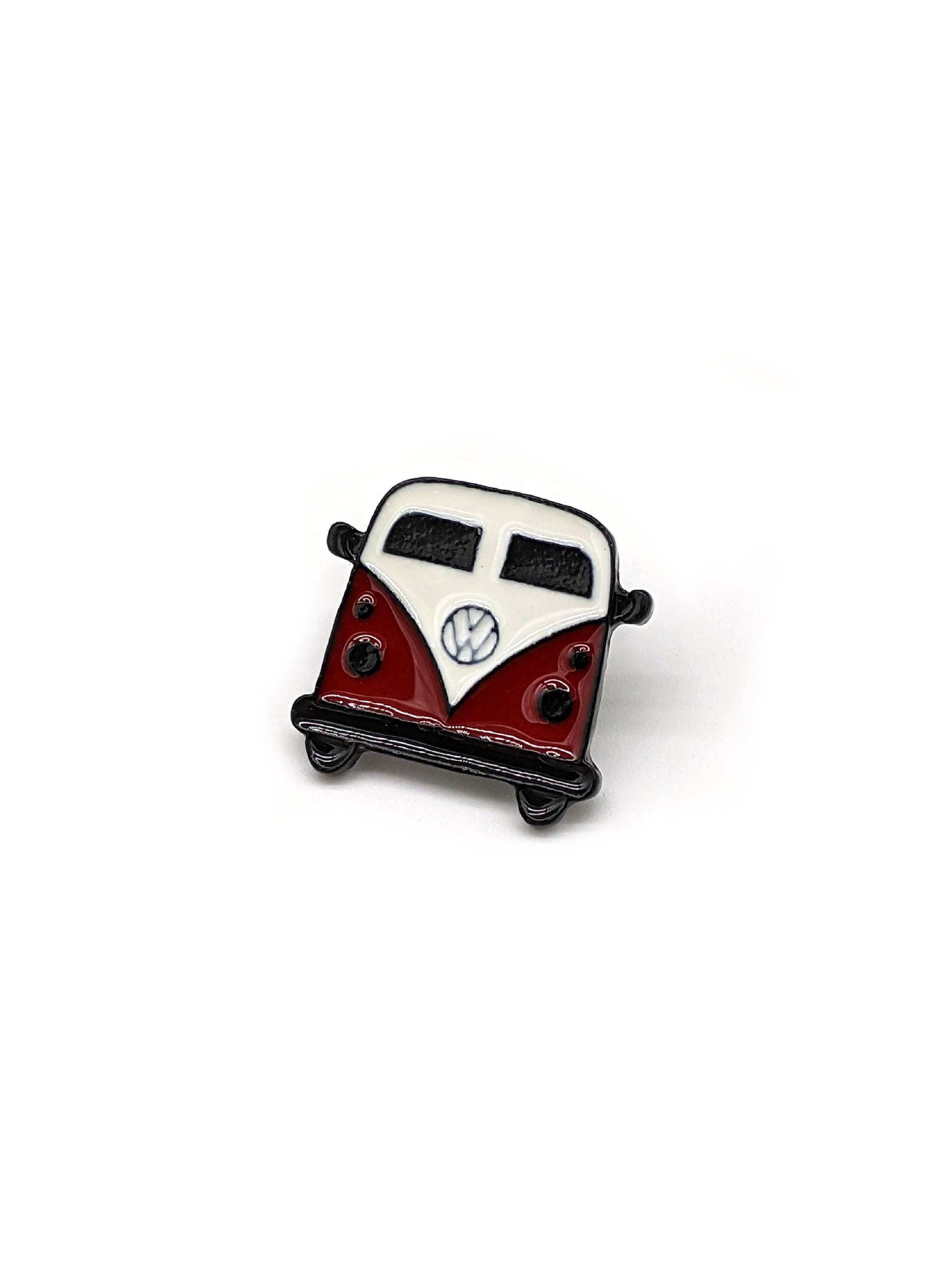 A brooch designed in the shape of a Volkswagen Camper van, intended to be attached to a hat.